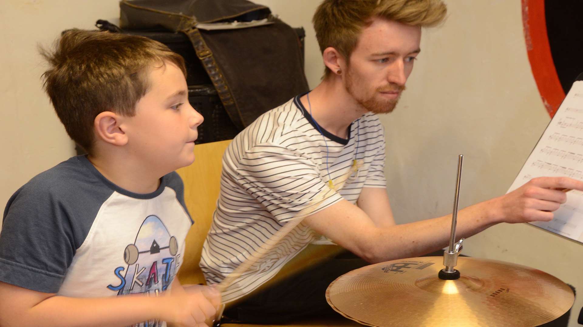 Oliver Nicholls, eight, with drum tutor Glenn Rice at Elephant Music. Picture: Gary Browne