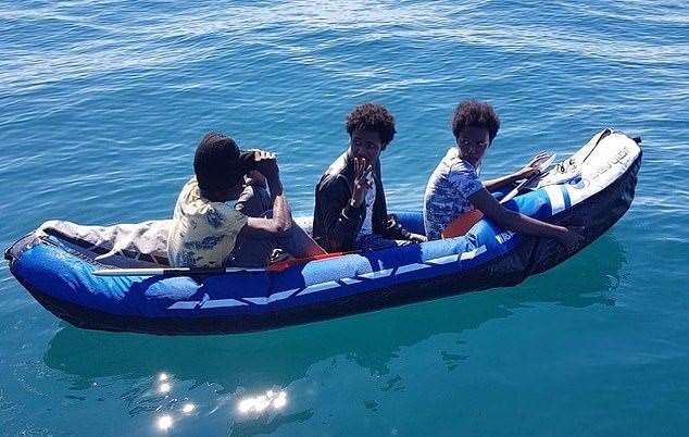 Three migrants were plucked from their sinking kayak in the Channel by the pilot boat of a channel swimmer