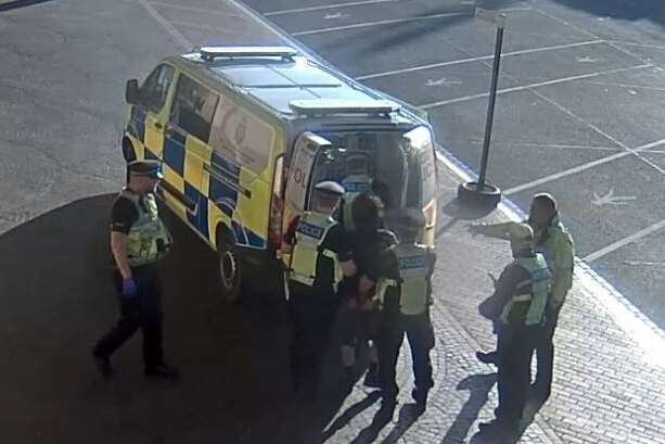Captured: Police haul Hassan into their van. Pictures courtesy of Metropolitan Police