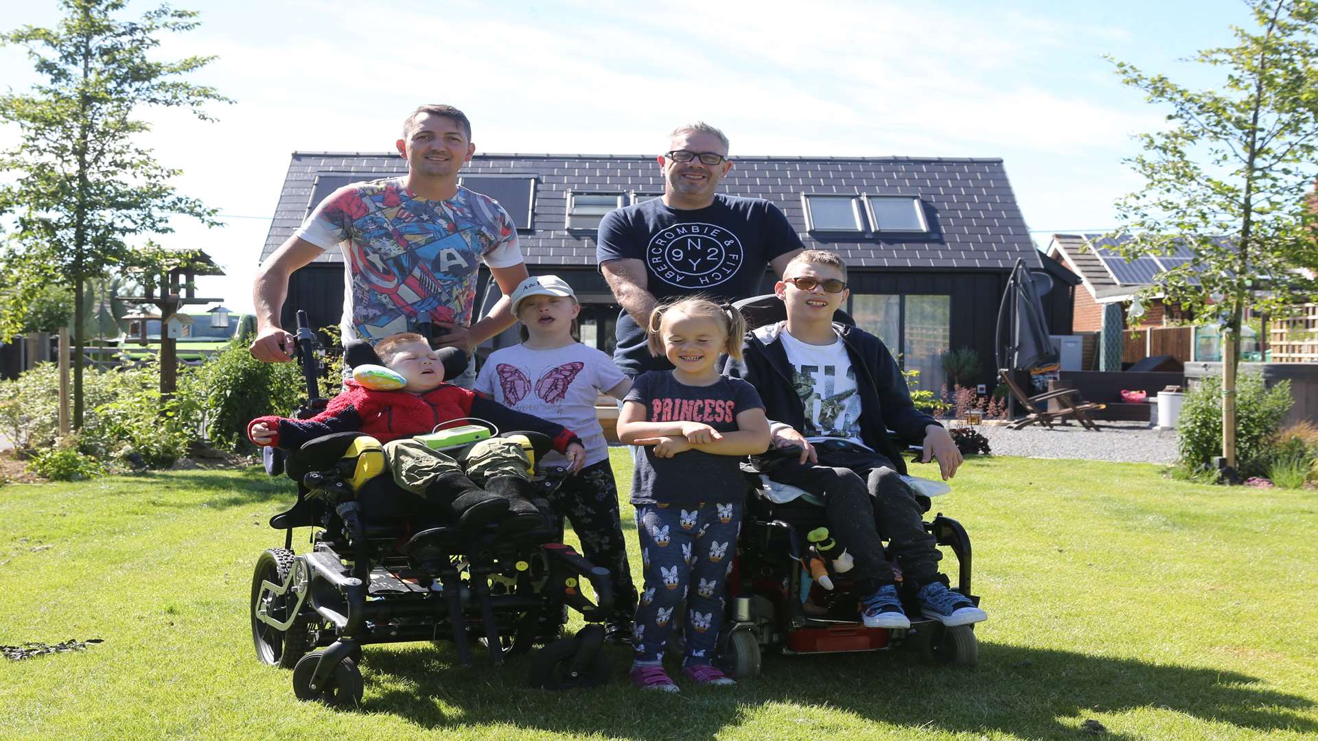Kyle and Garry Ratcliffe with their children Curtis, Bella, Phoebe and Haydn in their garden of the home DIY SOS built