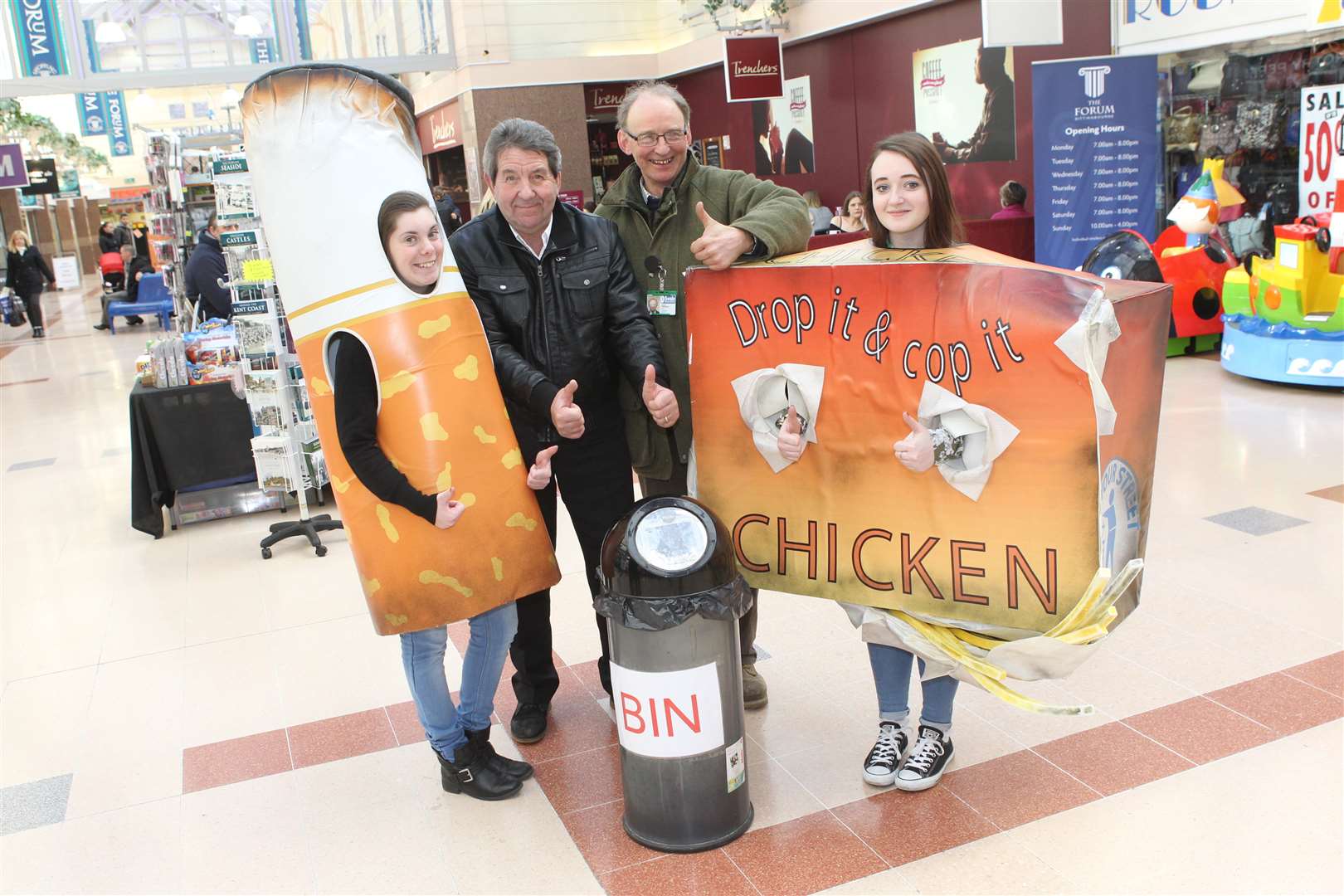 Hannah Lillis, 18, and Jazmin Cross, 16, apprentices dressed a cigarette and chips, with MP Gordon Henderson and Cllr David Simmons