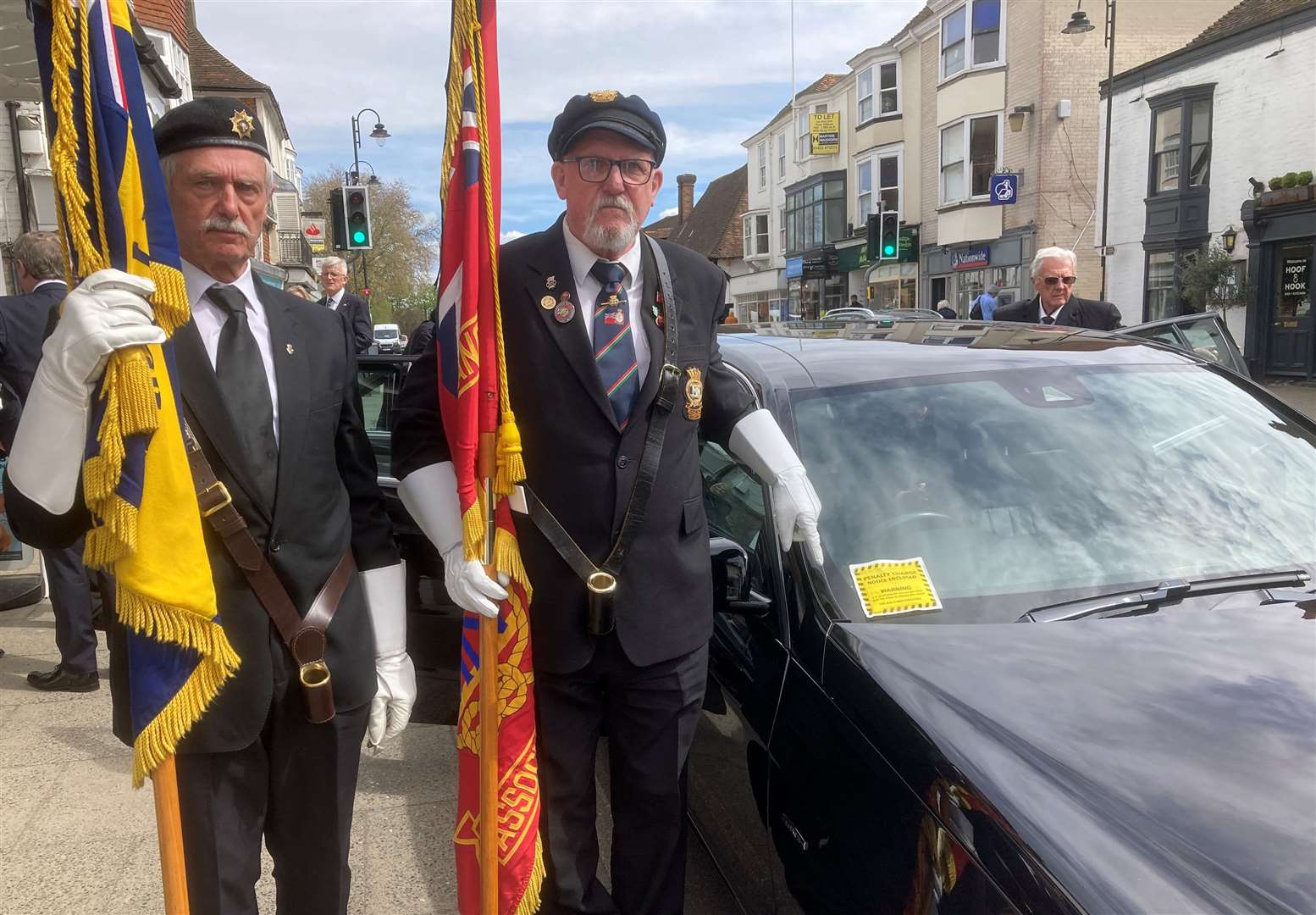 Representatives of the British Legion by the funeral limo with the parking ticket in Tenterden High Street. Picture: Lindsay Hammond