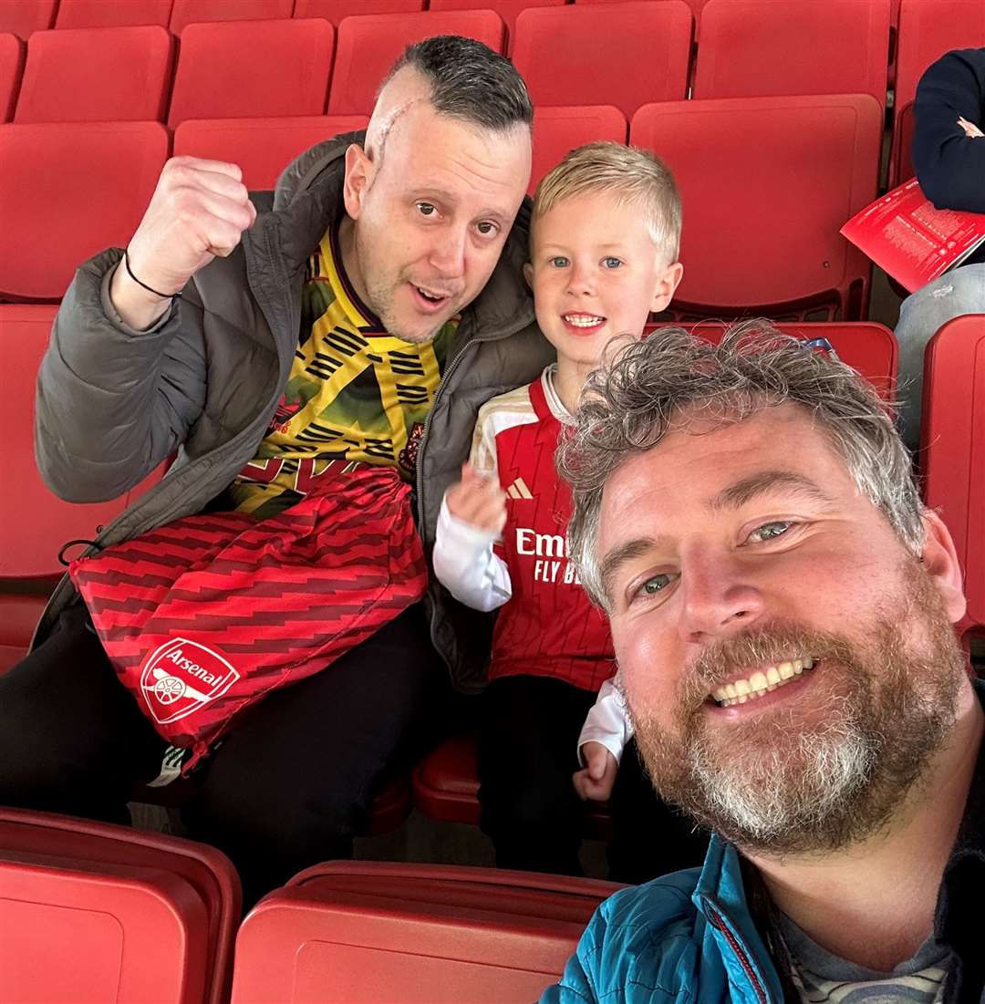 Watching their beloved Arsenal with John's son Ollie. Photo credit: Damien Clarkson