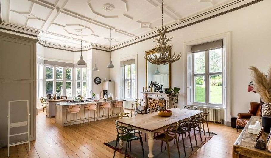 The kitchen and dining room have large windows looking out into the gardens. Picture: Hamptons