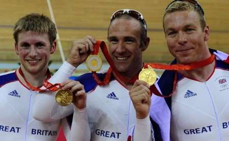 British track cyclists Jamie Staff (centre), Jason Kenny (left) and Chris Hoy (right) pose with their gold medals for the track cycling men's team sprint event. Picture courtesy PA