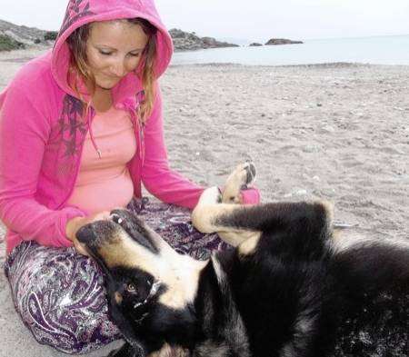 Rosie Homden with Sammy on a beach in Kos