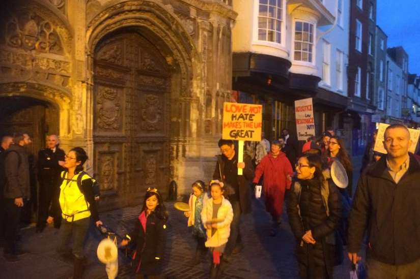 The protesters march past Canterbury Cathedral.
