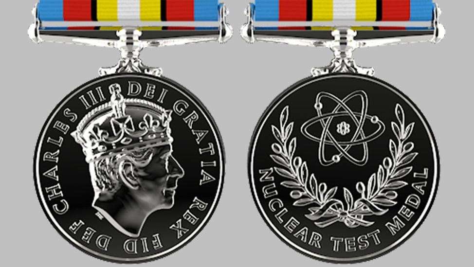 The Nuclear Test Medal depicts an atom, surrounded by the olive branches of peace