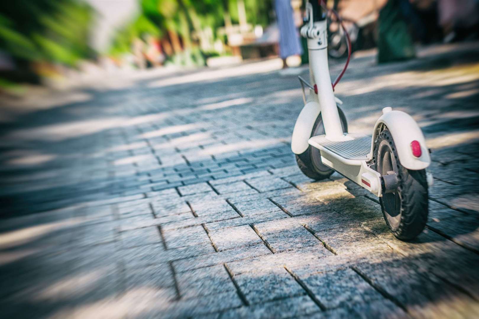 eco friendly transport electro scooter on city sidewalk tile in sunny day. (55242719)