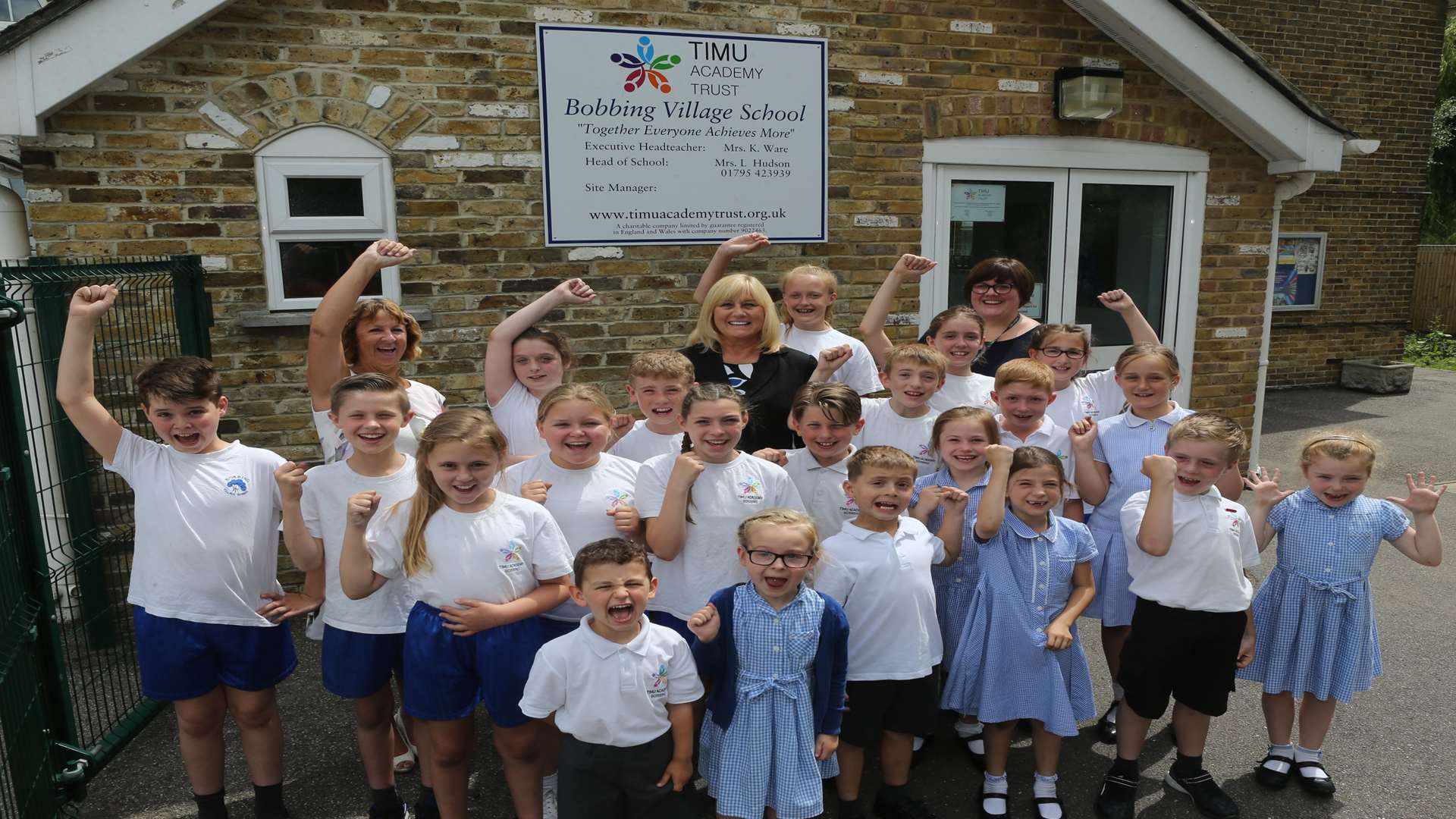 From left, Mrs Ware, Executive Principal, Mrs Hudson, Principal and Mrs Stewart, Assistant Head celebrate with some of the children from Bobbing Village School.