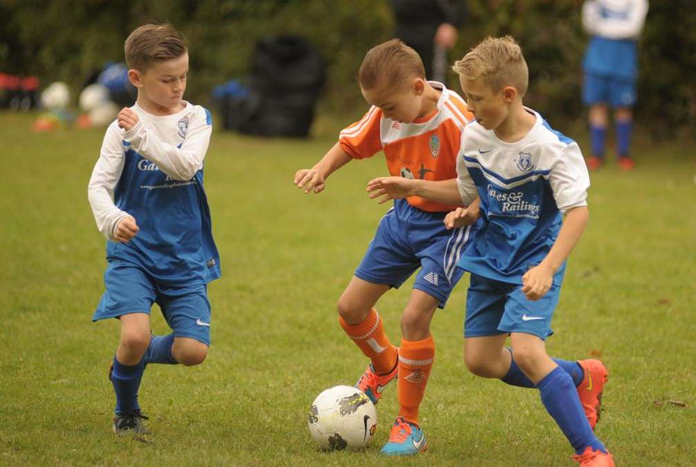 Cuxton Red Devils under-9s, in orange, outnumbered two-to-one by New Road Picture: Steve Crispe