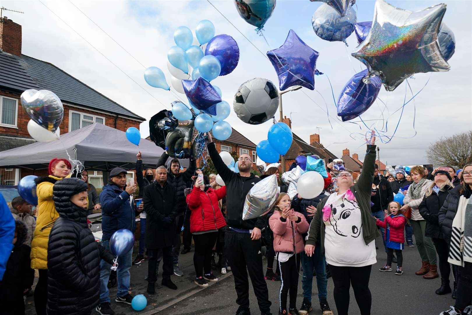 People release balloons during a tribute to six-year-old Arthur Labinjo-Hughes outside Emma Tustin’s former address in Solihull (Jacob King/PA)