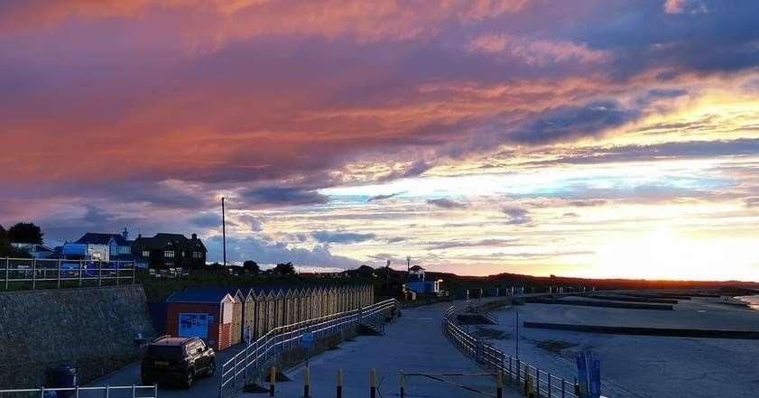 Colourful beach huts match the sky on 'The Bay of Sunsets'. Pic: Ian Noble.