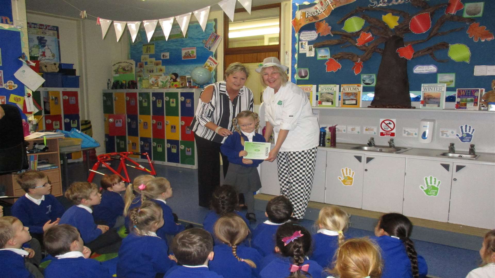 Mia Eastley of The Downs Primary receives her award from Whole School Meals