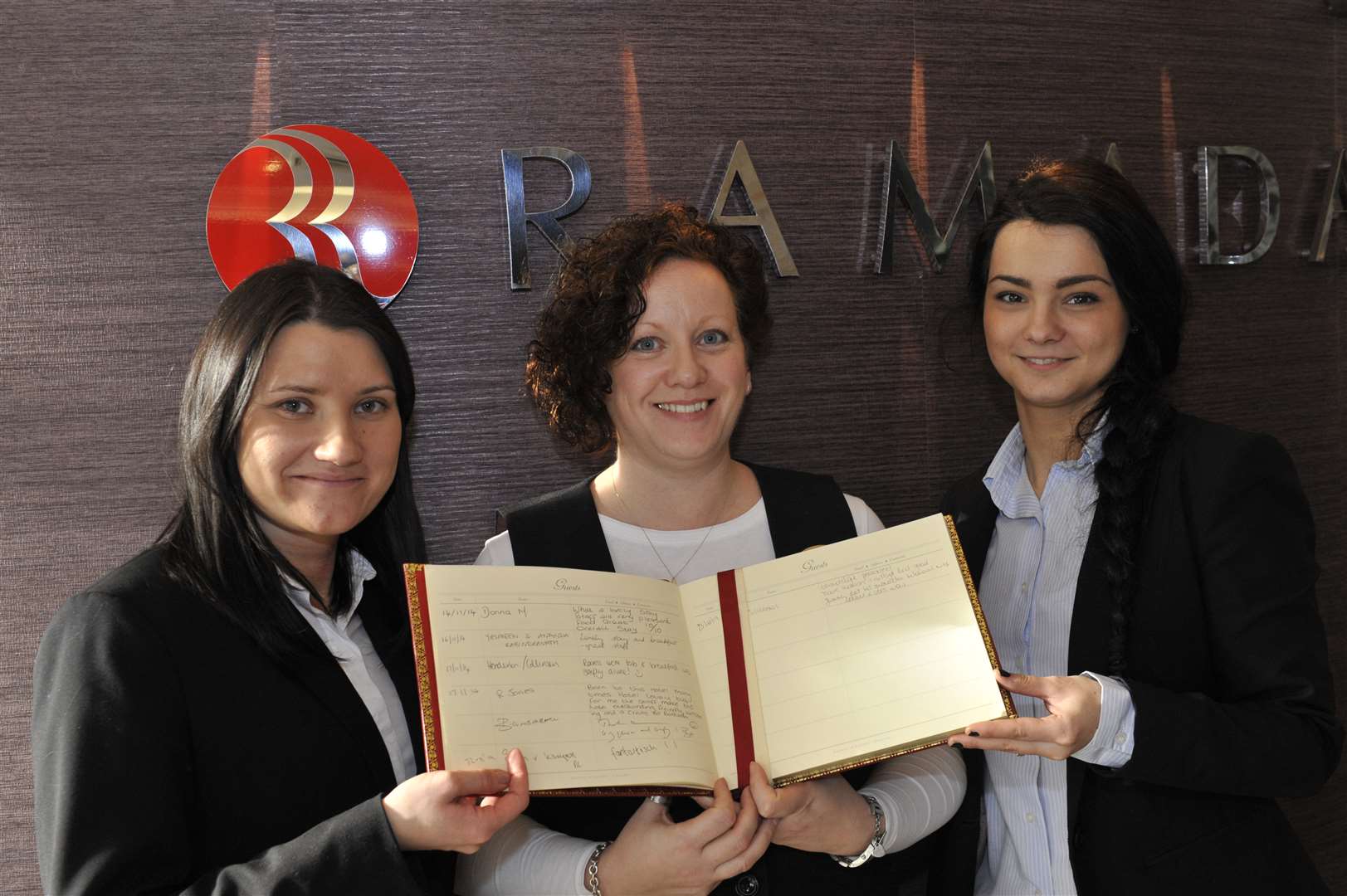 Hotel workers; Anna Brzozka, Sue Piddock and Andreea Gainariu hold up the guest book with Benedict Cumberbatch's kind words