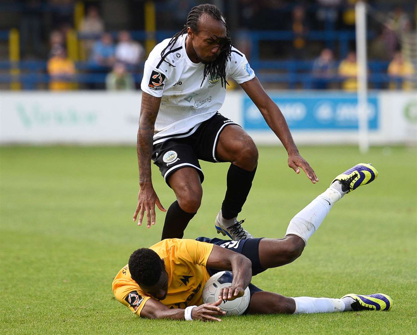 Dover's Ricky Modeste is held up by Torquay defender Jean Yves Koue Niate on Saturday Picture: Alan Langley