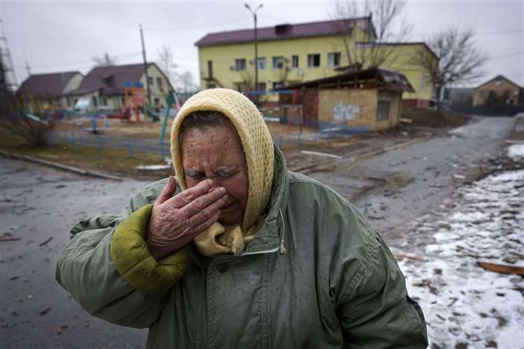 A woman cries outside houses damaged by a Russian air strike near the Ukrainian capital Kyiv. Picture: Vadim Ghirda/AP
