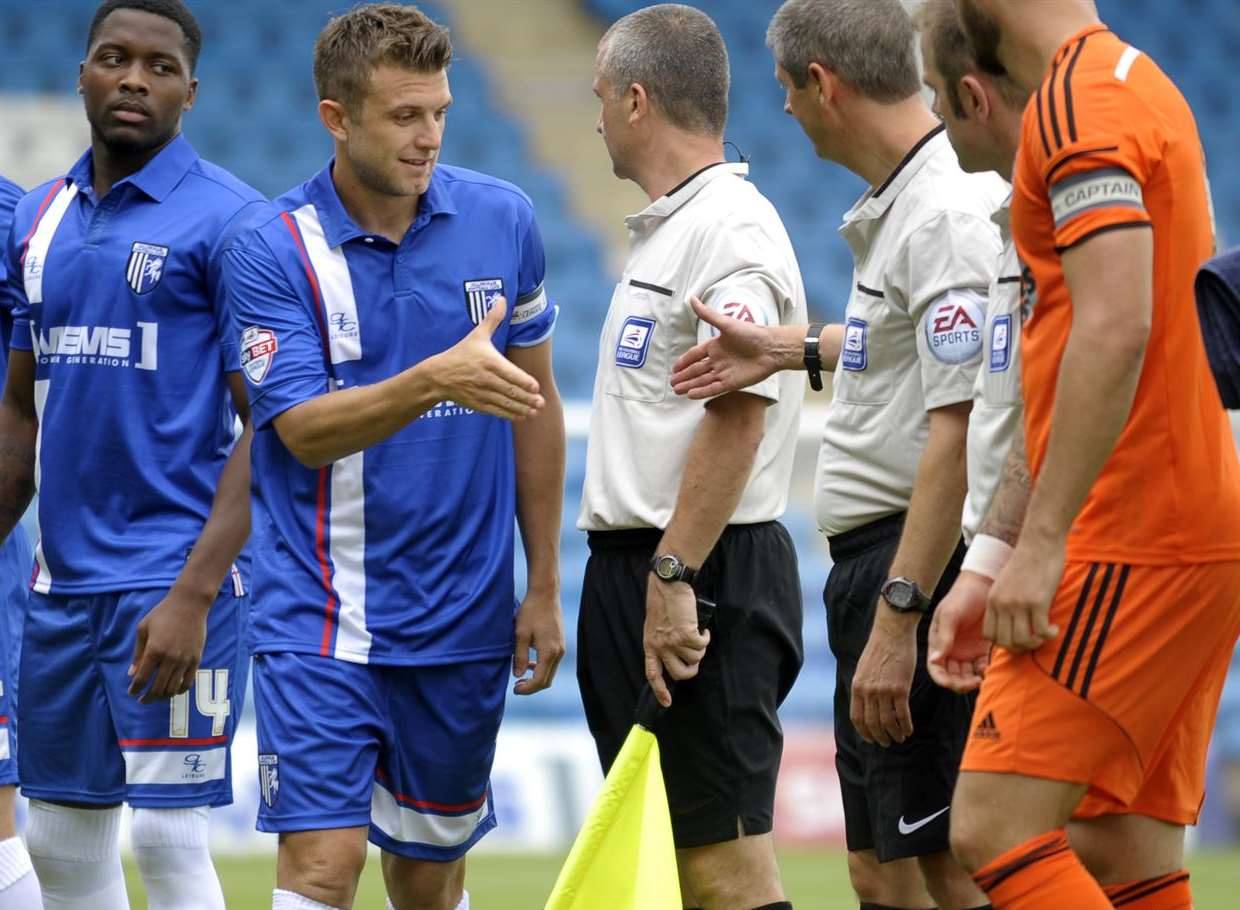 Doug Loft leads the Gills team on the pre-match handshakes against Ipswich. Picture: Barry Goodwin