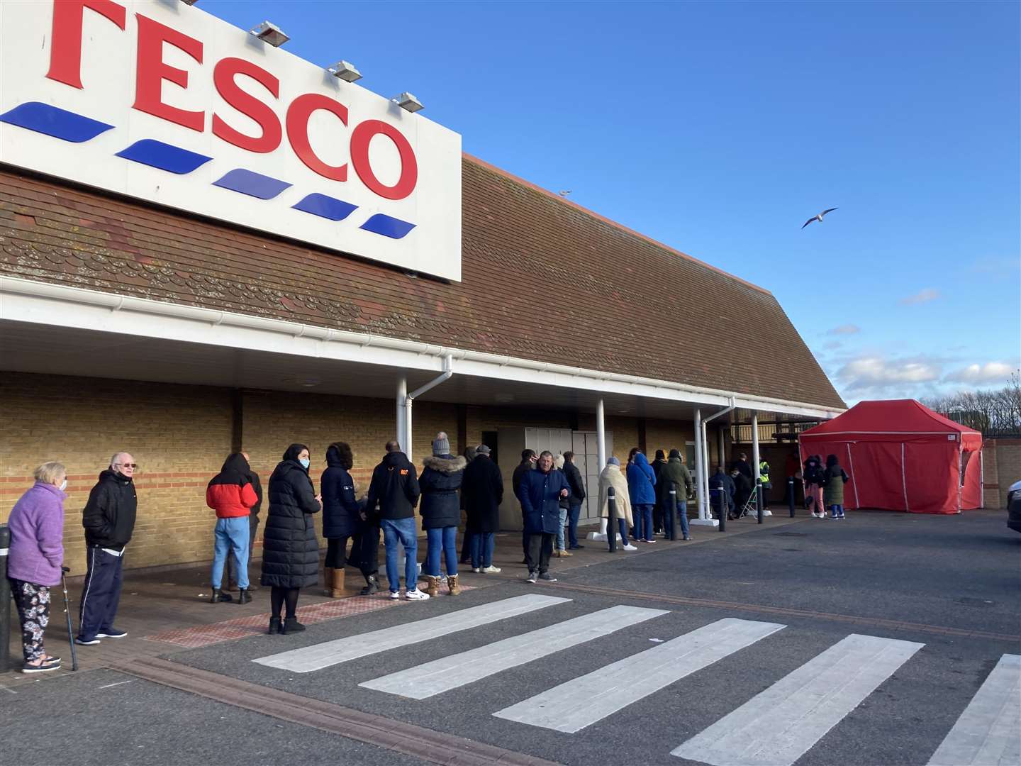 The queue to have a Covid booster jab stretched around Tesco supermarket in Bridge Road, Sheerness