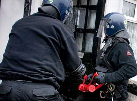 Police force their way into a property. Stock image: Kent Police