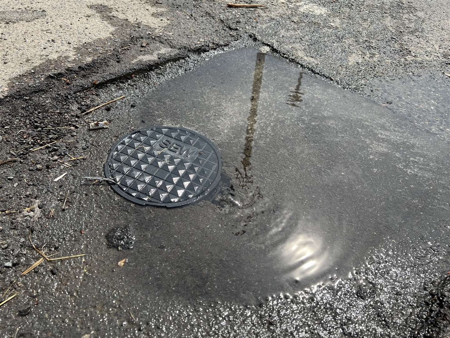 The leaking access cover outside Teynham Hand Car Wash