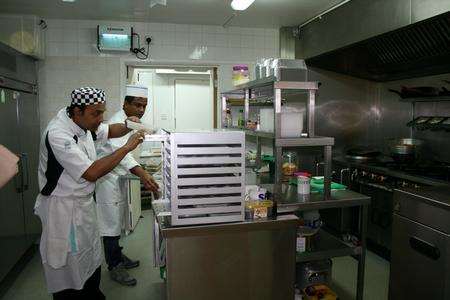 Staff at Taj Cuisine in Lower Stoke prepare to deliver Indian meal to Congo.