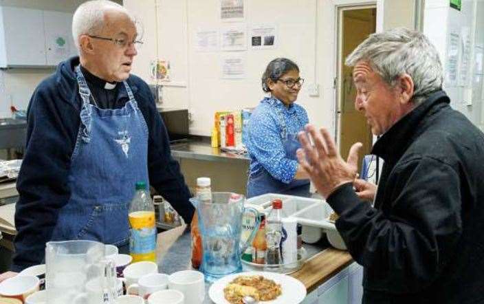 The Archbishop of Canterbury, serves lunch during his visit to the Catching Lives centre. Picture: Neil Turner/PA