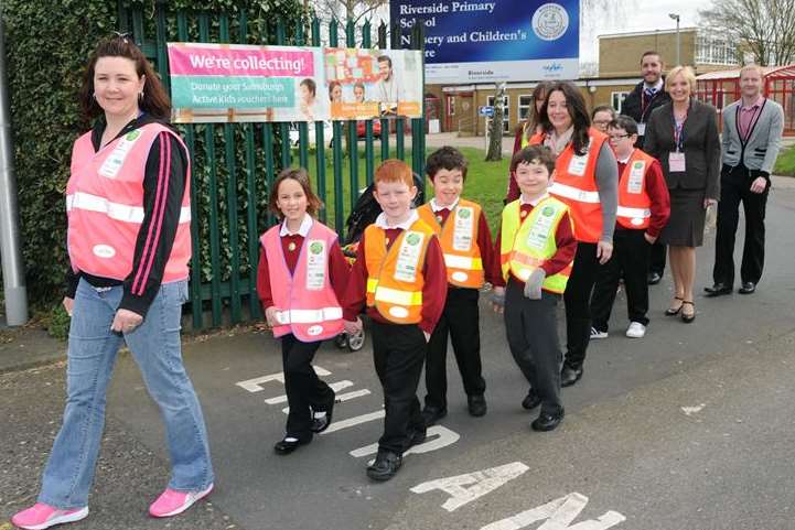 Parent co-ordinator Suzi Hill (left) with pupils, staff and volunteers on Riverside Primary School's walking bus