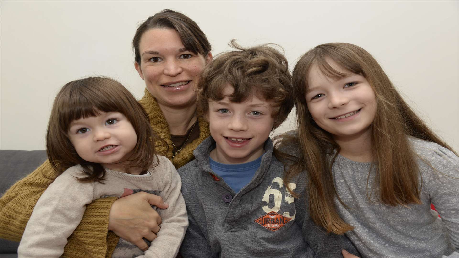 Krista Nelson and son Oliver, nine, with his sisters Evelyn, two and Jessica, 10