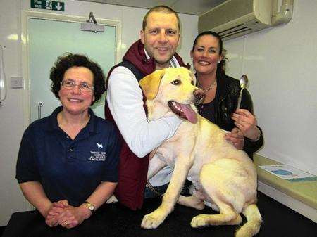 Golden labrador Scooby with owners Paul Cooper and Marie Regan of Ramsgate and Thanet Animal Hospital head vet Jill Matthews.
