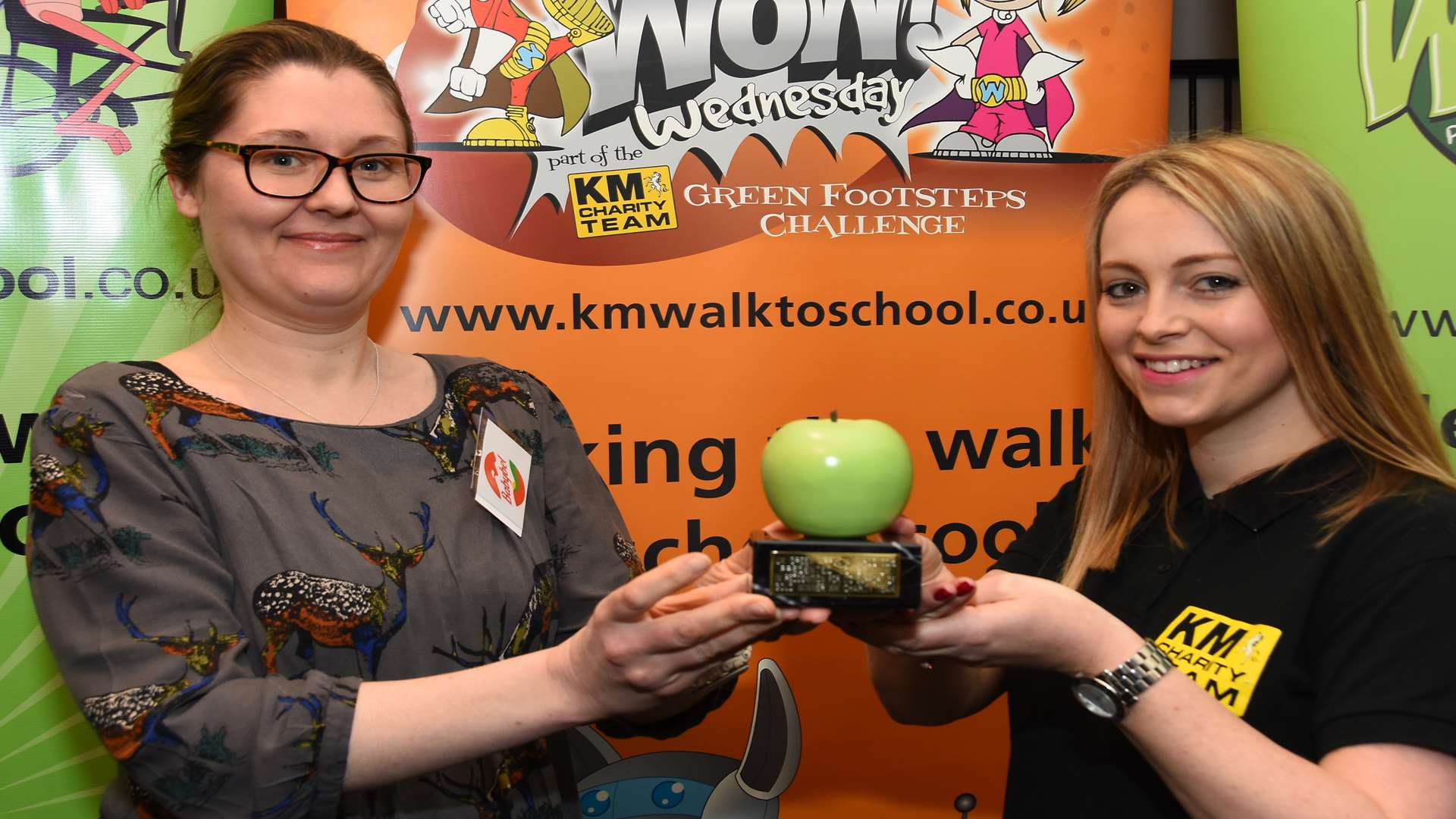 Sophie Wallace of the KM Charity Team presents Chloe Feminier of Bel UK with a Green Apple environmental award at the KM Charity Team Partnership Awards at Hempstead House, Sittingbourne