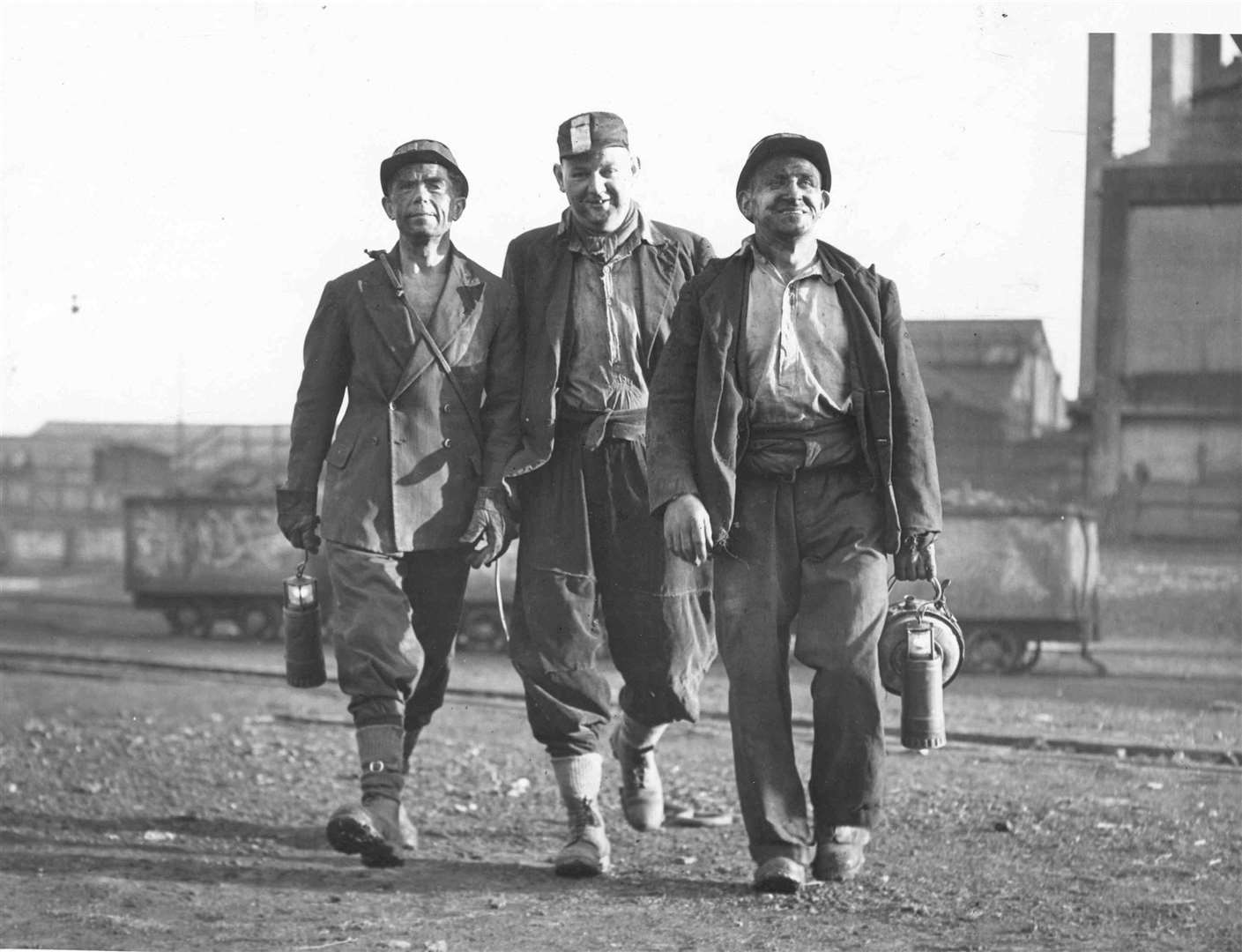This picture shows three of the miners leaving the pit. l to r: T A K Shipwright, an ex RAF Officer who was invalided after serving twenty six years and volunteered for the mines last September, George Daughtrey, who started work in the Yorkshire pits at the age of 14, and Jack Adams who came from the Welsh mines to Kent. George Daughtrey will introduce Shipwright. Picture supplied by BBC