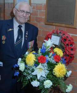 LAST SURVIVOR: Fred Henley lays a wreath for his fallen shipmates
