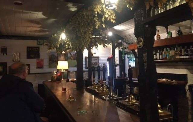 Beams, a low ceiling and as traditional a bar as you’ll find anywhere, bedecked with lanterns and hops