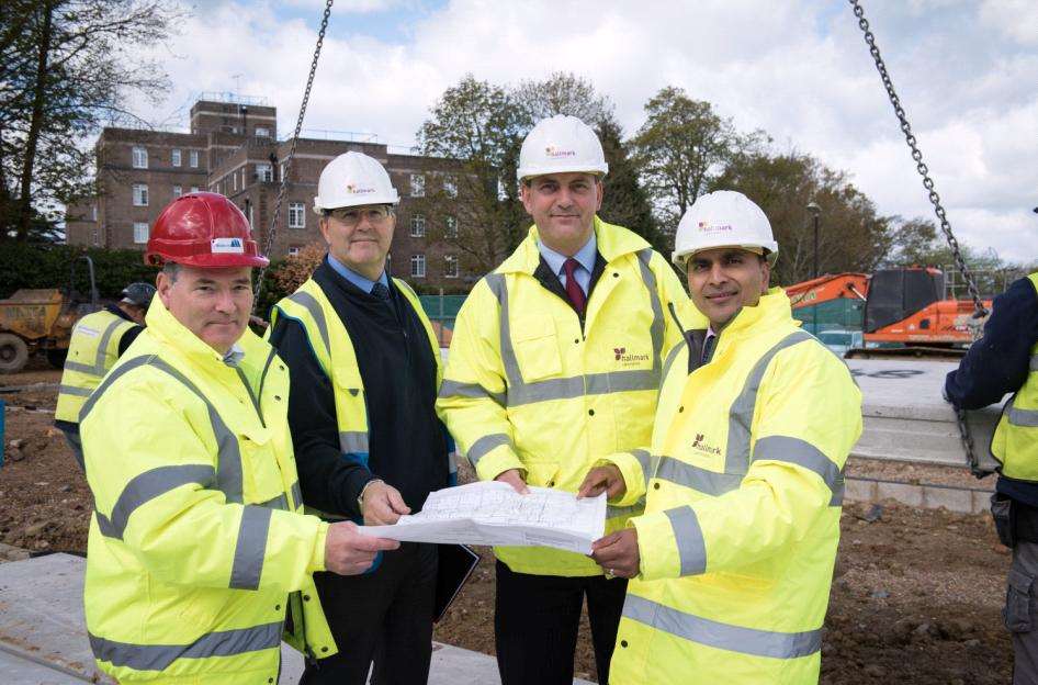 Construction site team look at the building plans with Hallmark Care Homes, MD Avnish Goyal