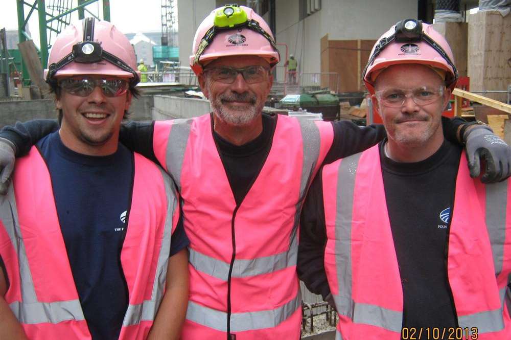 From left, Kyle Sanders, Mark Wratten and Travis Belsom wear pink at Pancras Square, Kings Cross, to support their boss David Bracey who has cancer
