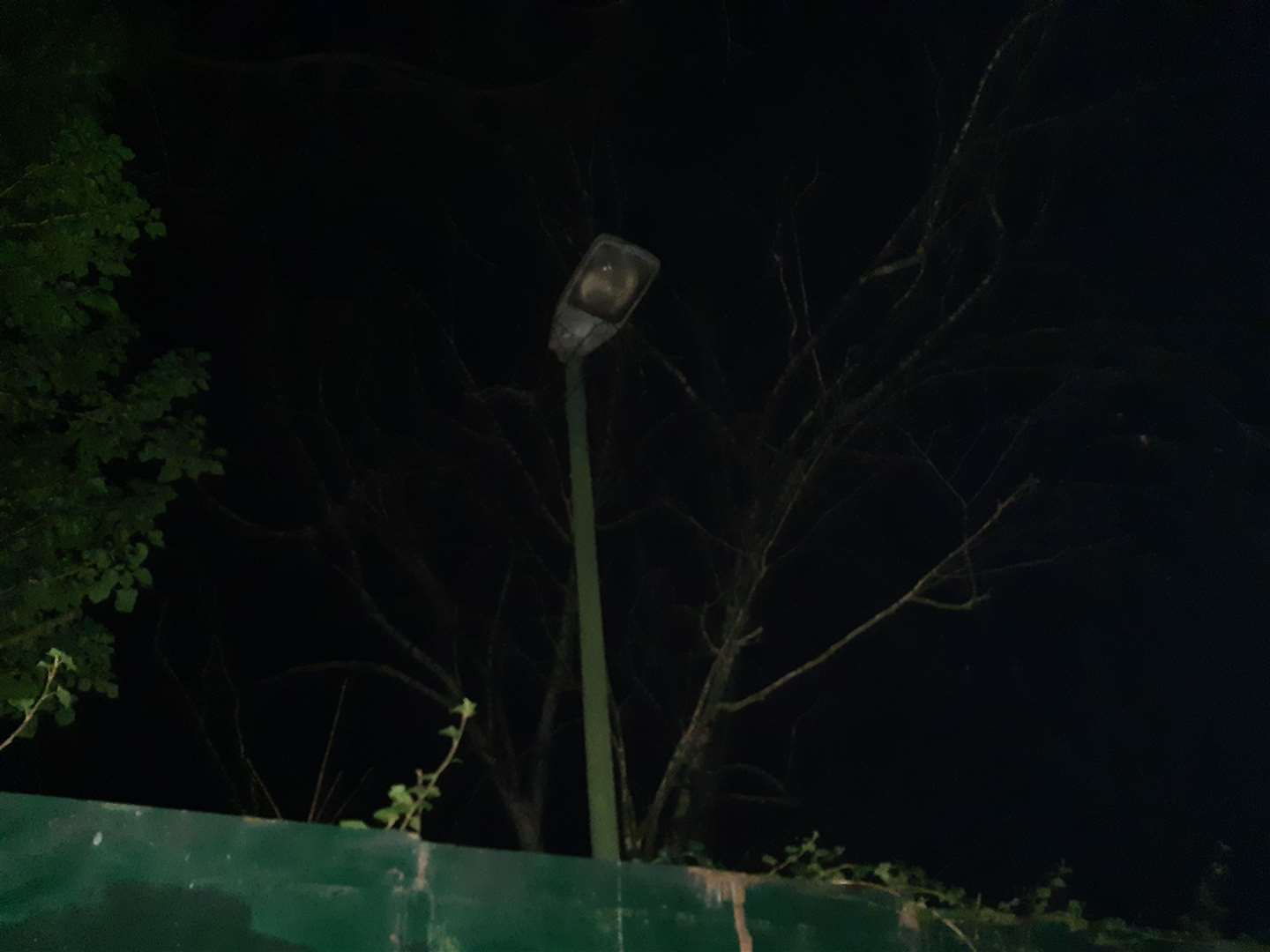A defective street light on the wrong side of the hoardings