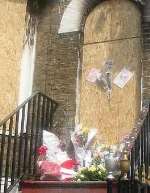Floral tributes to the victims outside the building where they died. Picture: PETER BARNETT