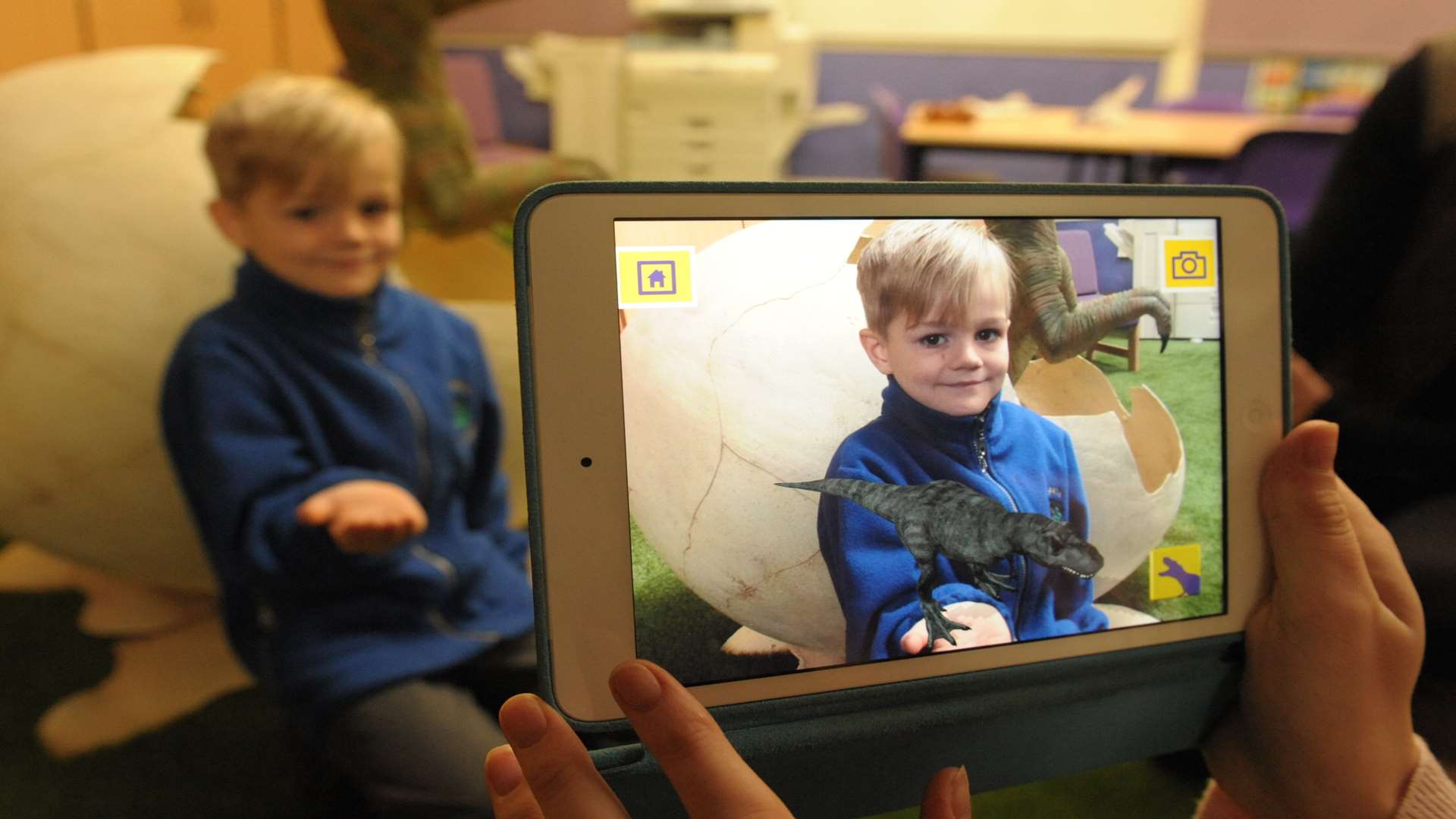 George being shown the KM i3d App which animates dinosaurs on an phone or tablet at Swingate Primary School, Sultan Road, Lordswood