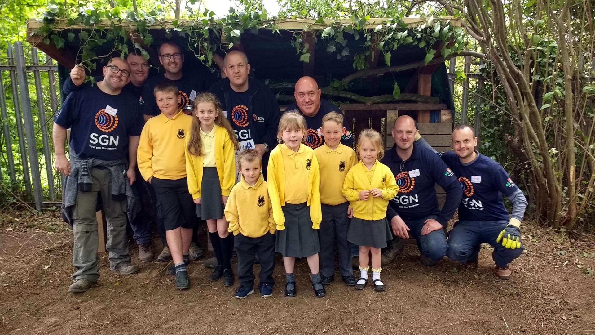 The SGN team show some of the High Firs pupils the shelter in their new outdoor classroom.