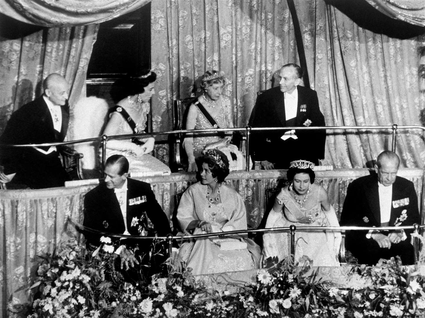 The Queen in the royal box with future PM the Earl of Home (Sir Alec Douglas-Home – back row, far right) at London’s Aldwych Theatre in 1963 (PA)