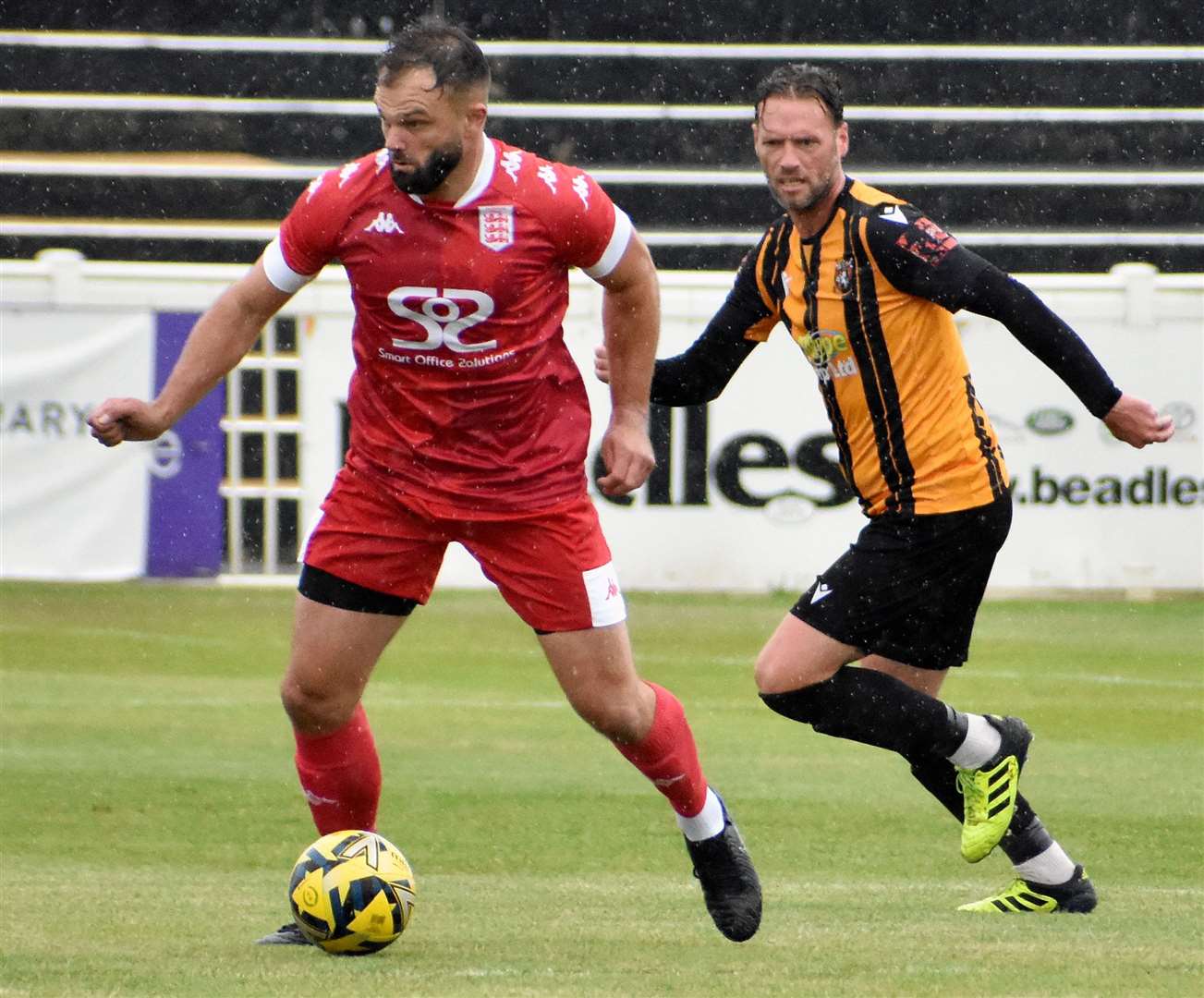 Faversham’s Gary Lockyer tries to escape the attention of Folkestone player-coach Andy Drury. Picture: Randolph File