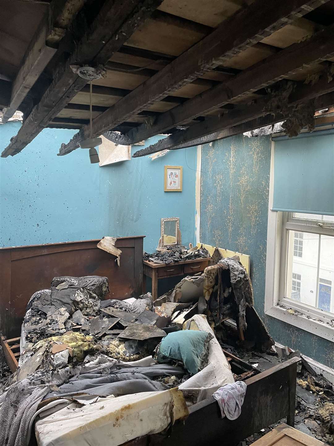 A wrecked bedroom after the fire. Picture from Zoey Cross