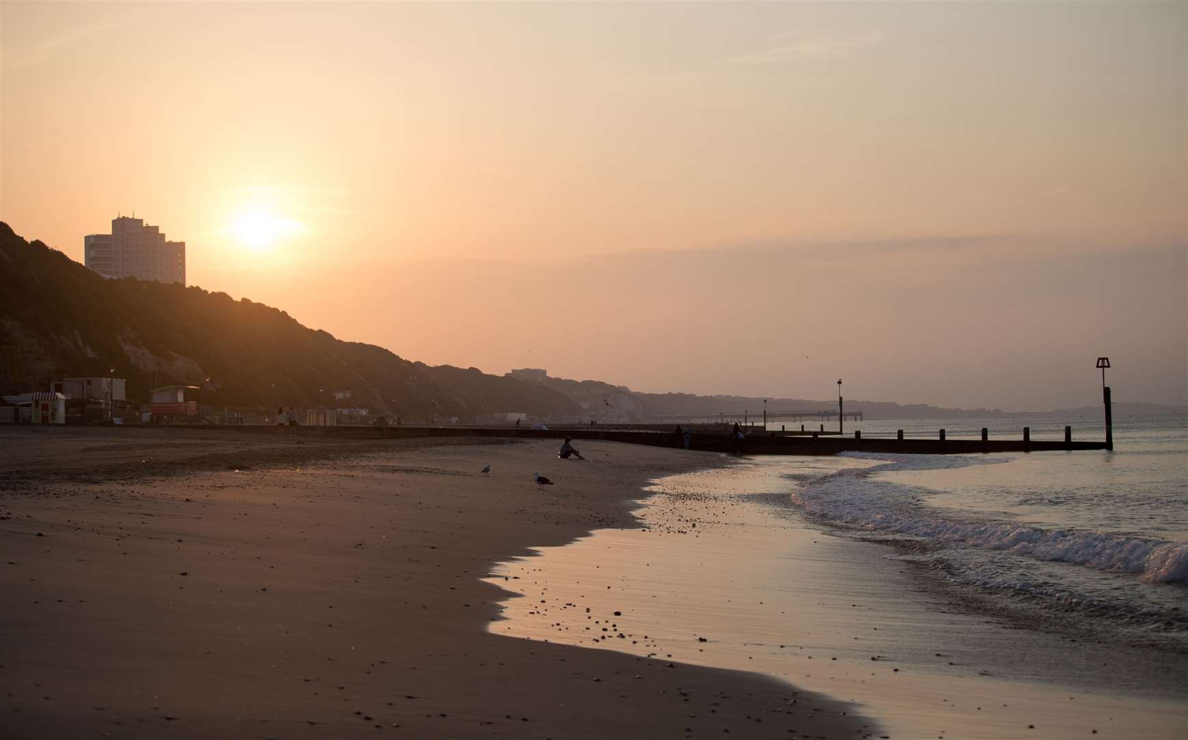 The sun rises over Bournemouth beach in Dorset (Andrew Matthews/PA)