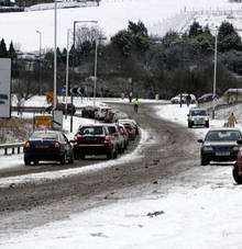 Motorists struggle in the snow at Hawkinge, near Folkestone during last month's snow. Picture Terry Scott