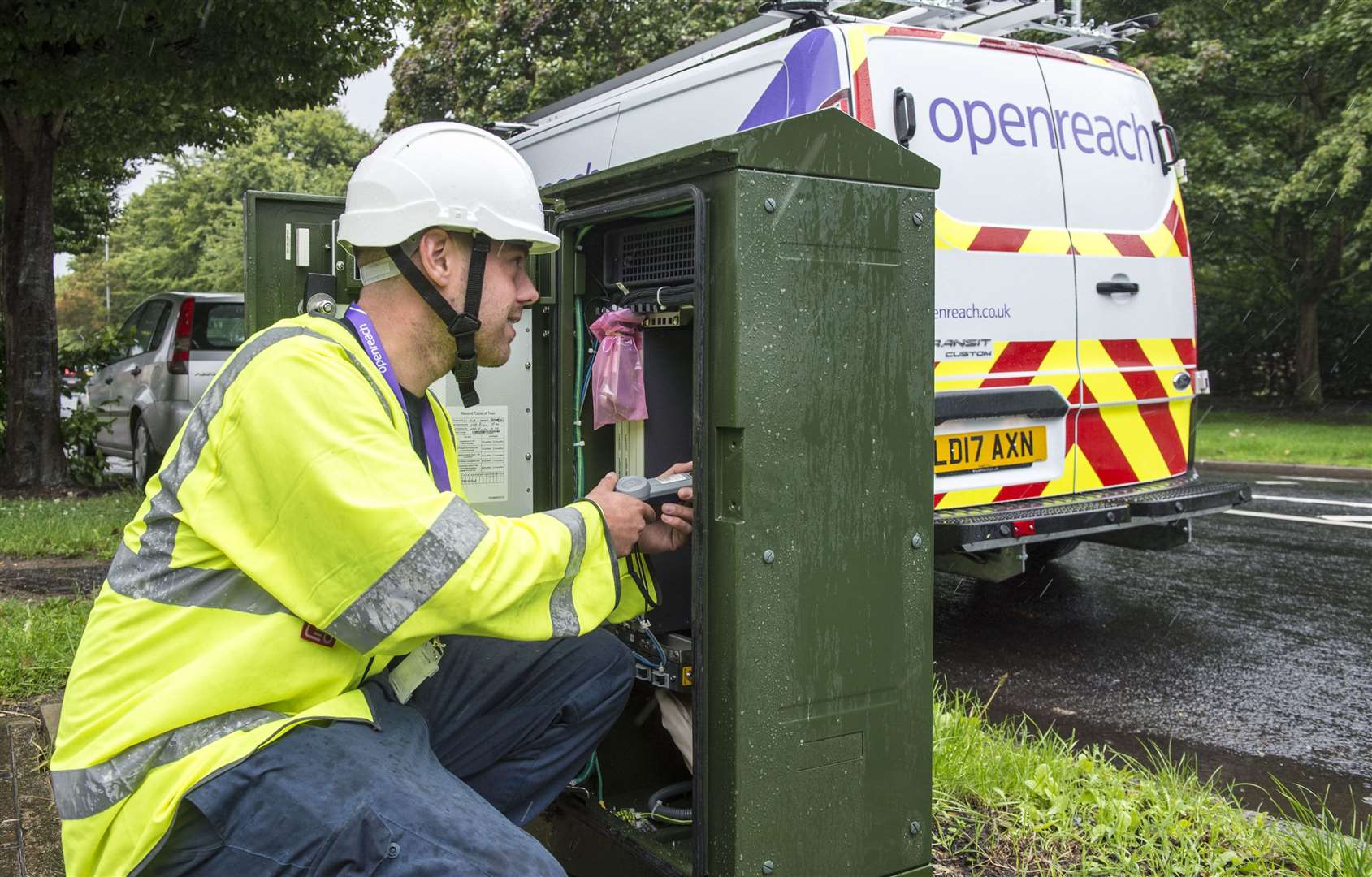 An Openreach engineer at work on a roadside cabinet