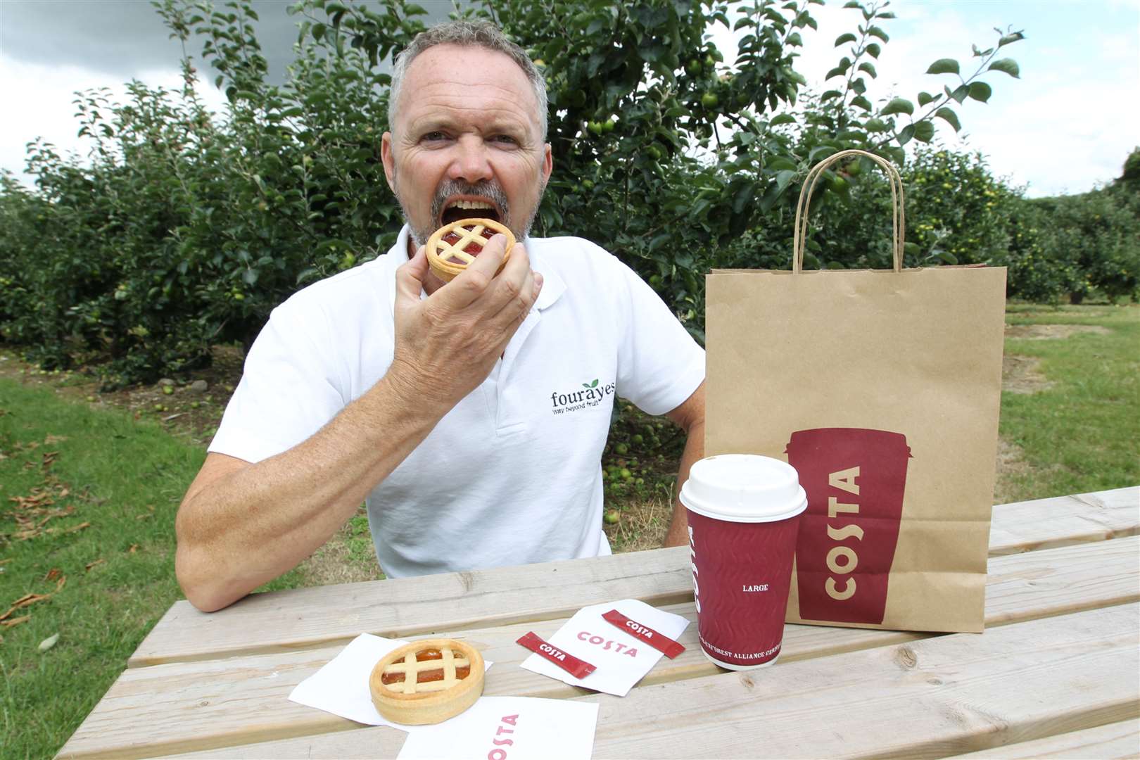 Fourayes managing director Phil Acock munches a strawberry and rhubarb fruit tart his company developed for Costa