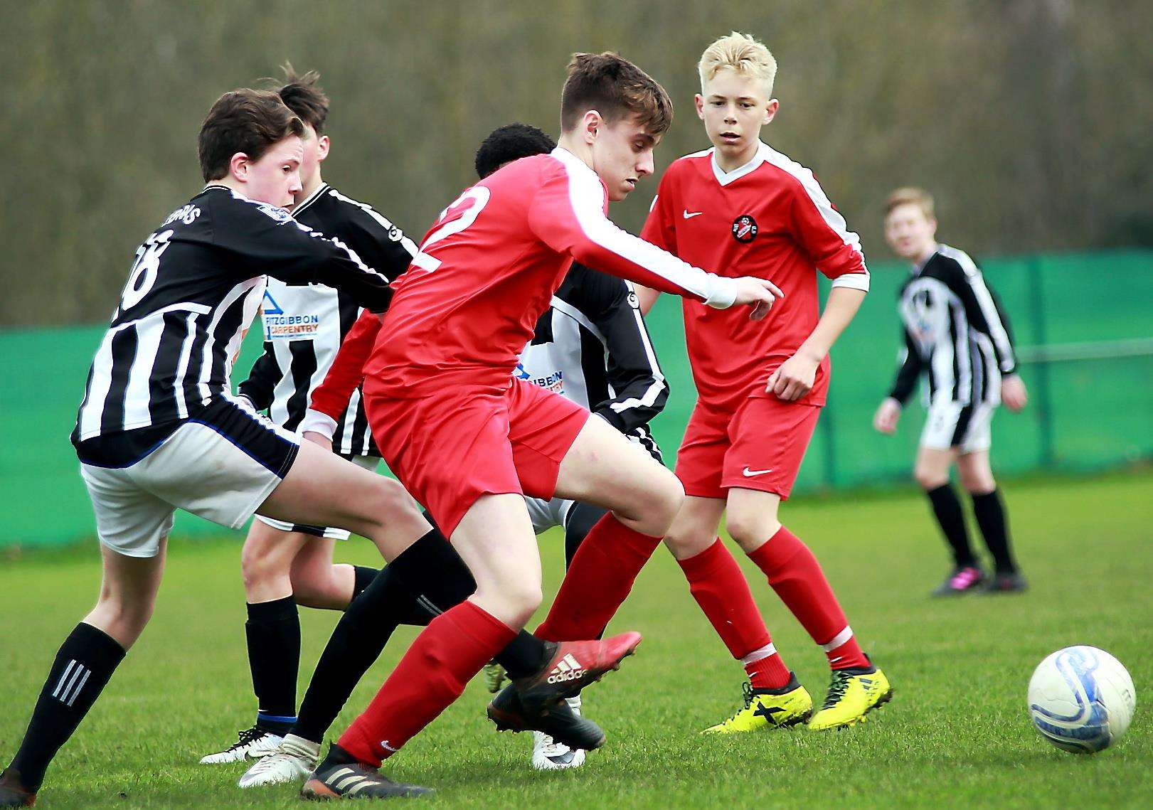 Rainham Kenilworth under-14s (red) in action against Milton & Fulston United under-14s during their League Cup final on Sunday. Picture: Phil Lee FM1498089