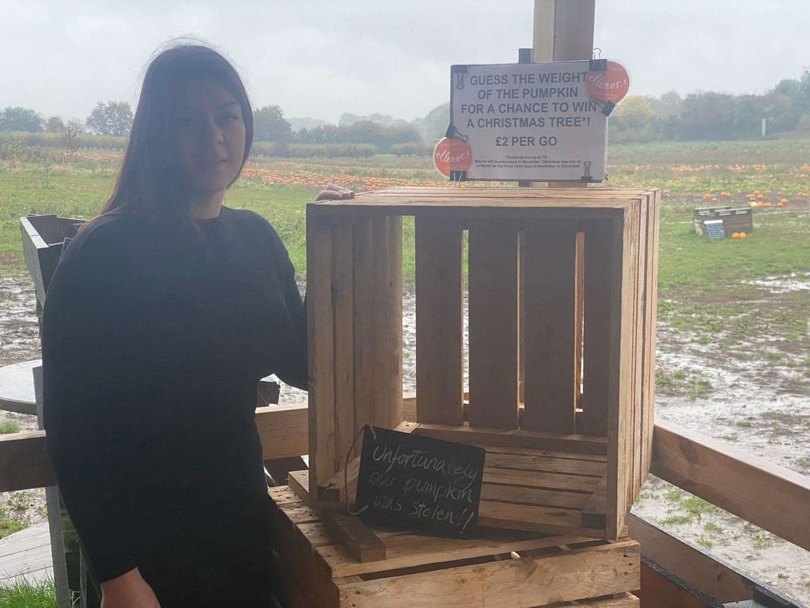 Emily Walker, who helps run the farm, poses with the empty pumpkin box. Picture: Becky Brown