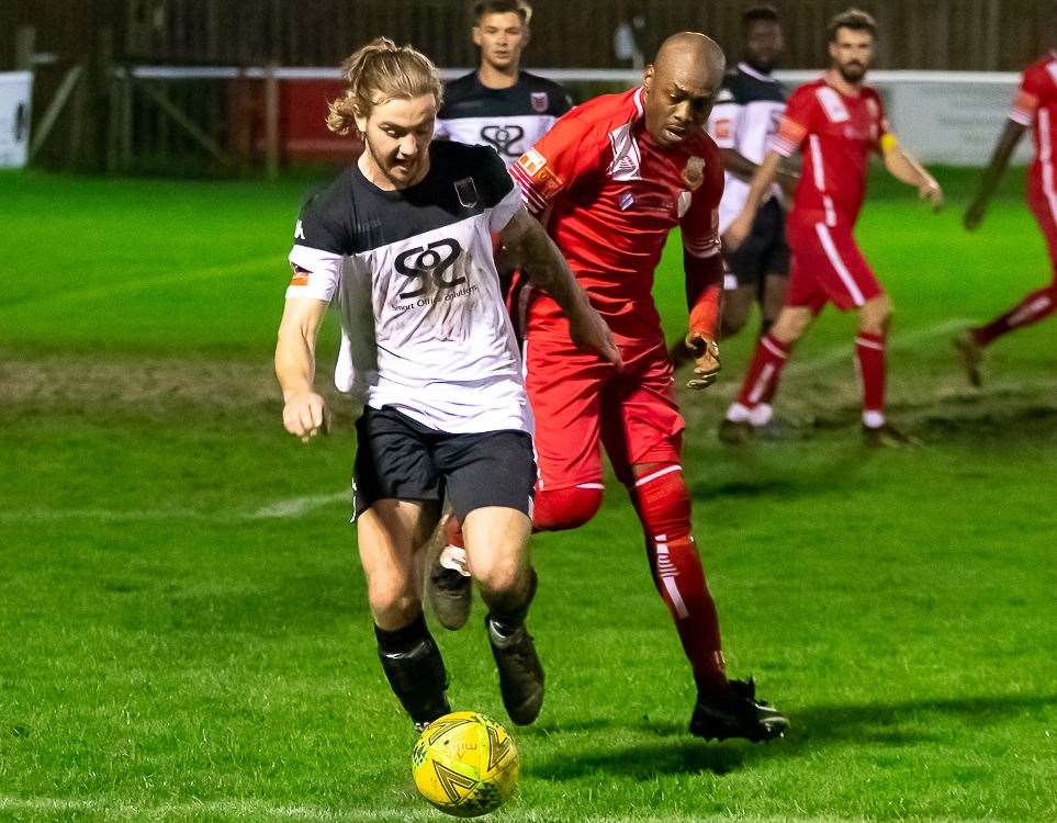 Faversham's Lewis Chambers tries to escape the close attention of Whitstable's Junior Baker during their 2-1 home defeat on Monday. Picture: Les Biggs